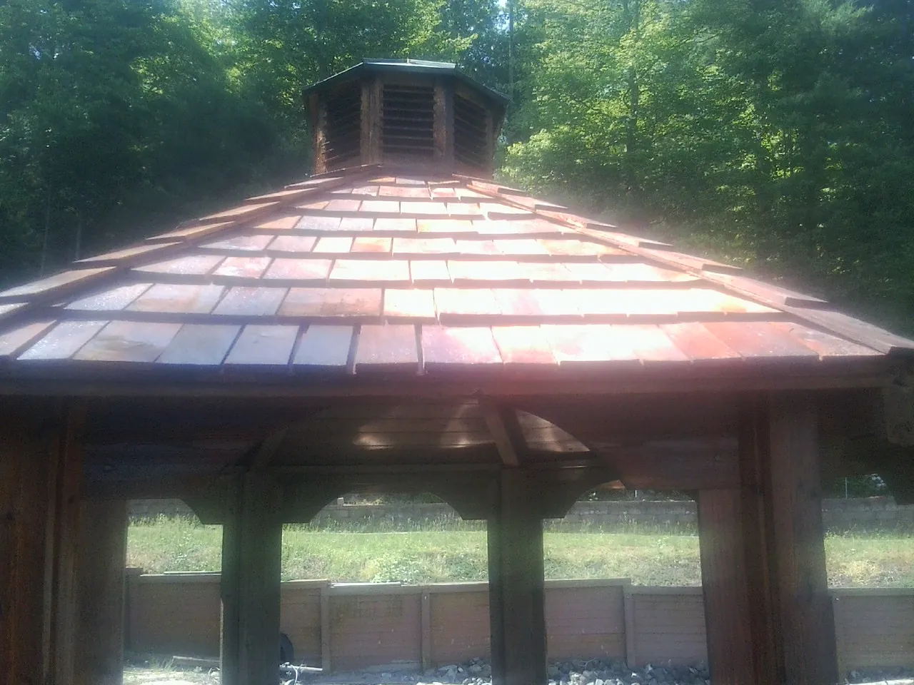 New cedar shake roof and cupola on a lakeside gazebo in Jessieville