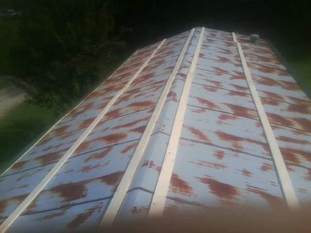 Rusted metal roof panels with new wood purlins before replacement — Storm Damage Roof Repair in Jessieville by Roofing Brothers